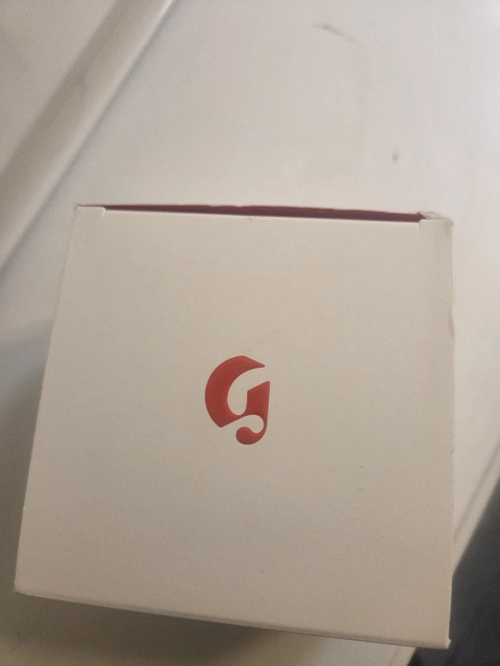 Glossier cream white with red stripe